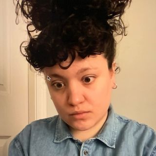 Felicity stares off camera. A stray mouse cursor reveals this is a screenshot.